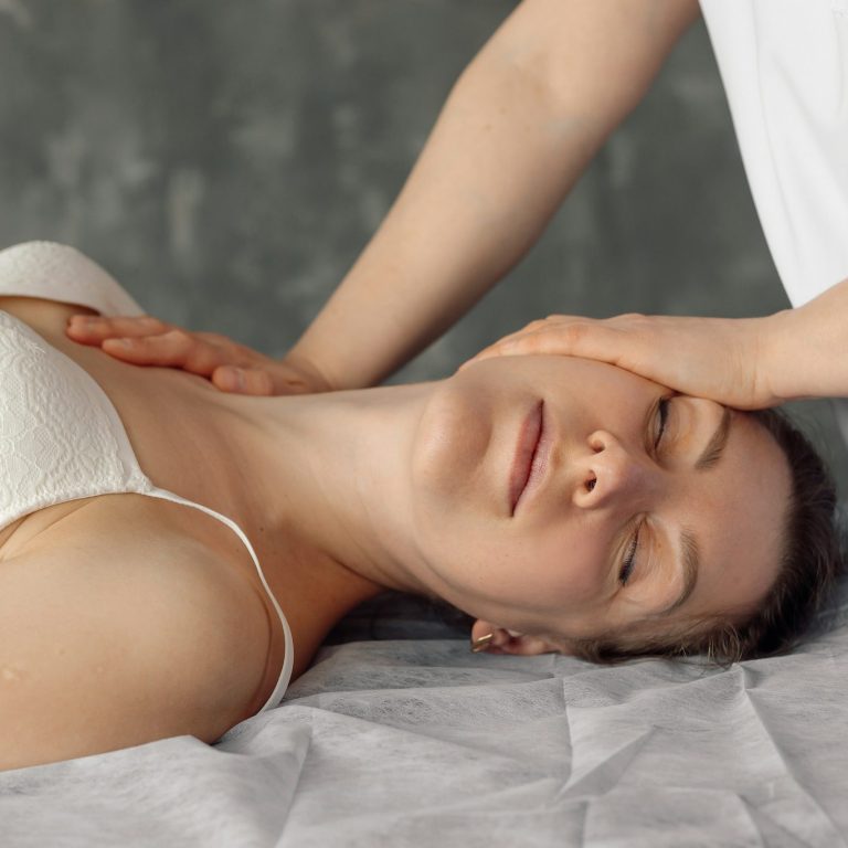 Neck Massage for Migraine Treatment A person receiving a neck massage, appearing relaxed and at ease.